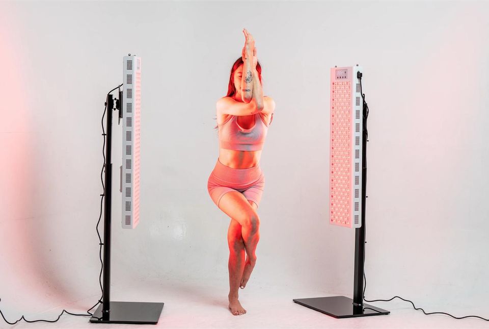 A woman in a yoga pose between RedRush panels