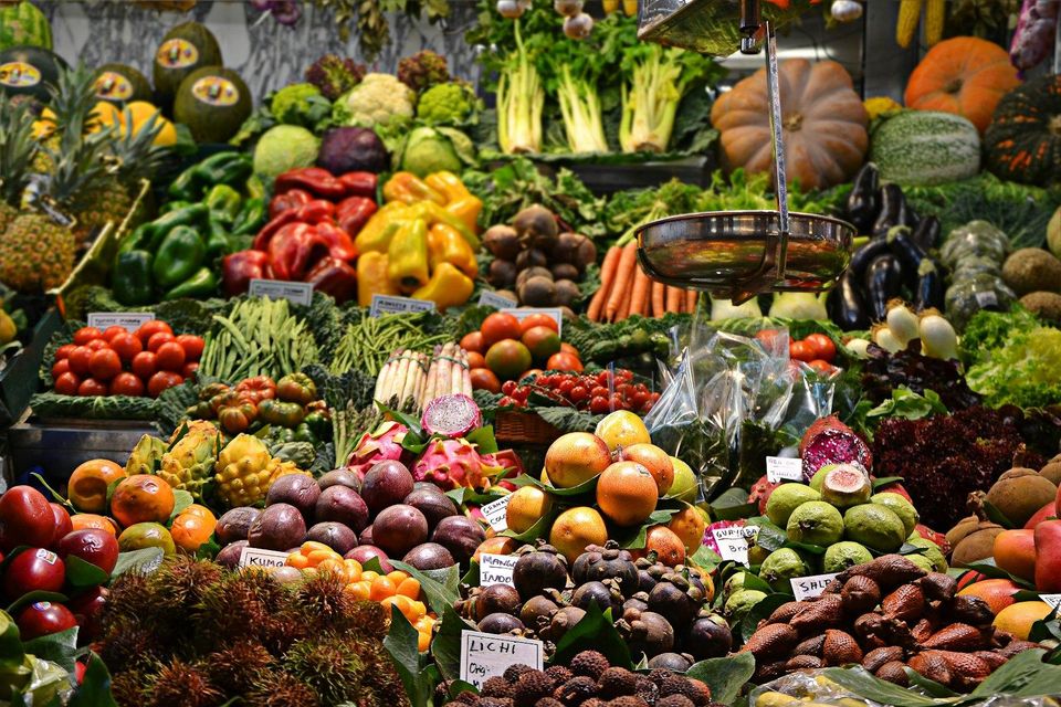 Produce stalls piled with fresh fruit and vegetables